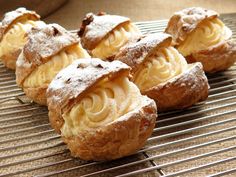 several pastries on a cooling rack with powdered sugar