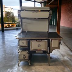 an old fashioned stove sitting inside of a building