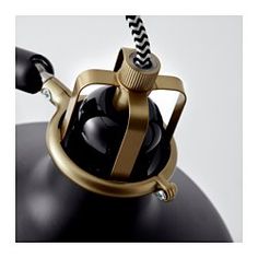 a black and gold tea kettle with a straw sticking out of it's top