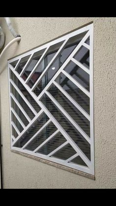 an image of a window that is on the side of a building with shutters