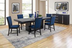 a dining room table with blue chairs around it