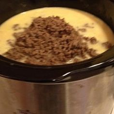 a crock pot filled with food sitting on top of a stove