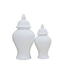 two white vases sitting next to each other