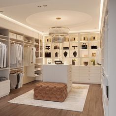 a large walk in closet with lots of clothes on shelves and an ottoman sitting on the floor