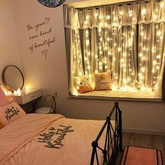 a bedroom with fairy lights on the windowsill