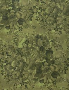 a green and black floral print fabric with large flowers on the bottom half of it