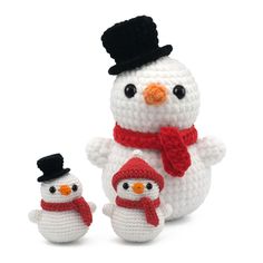 a crocheted snowman and two small penguins are shown in front of each other