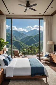 a bedroom with a large window overlooking the mountains