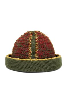 a red and green hat on top of a white surface