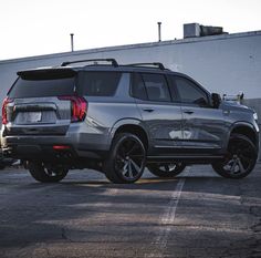 an suv parked in a parking lot next to a building