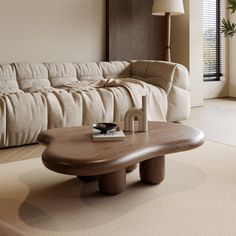 a living room with a couch, coffee table and large window in the back ground