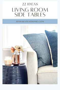 living room with blue and white pillows on the couch, coffee table and vases