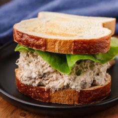 a close up of a sandwich on a plate with lettuce and meat in it