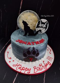 a birthday cake with a wolf and moon on it