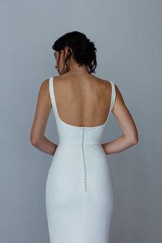 the back of a woman in a white dress