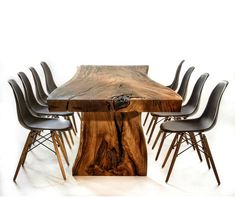 a wooden table with chairs around it and a piece of wood on the top that has been cut in half