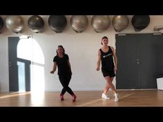 two women are dancing in a dance studio