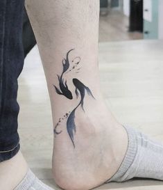 a person with a fish tattoo on their foot