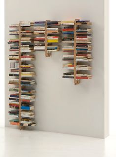 a book shelf made out of books in the shape of letters f and f on a white wall