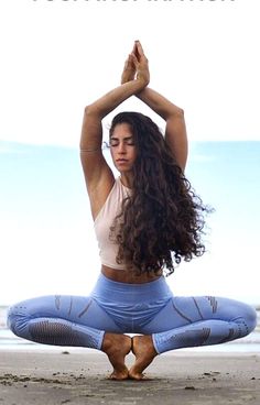 a woman doing yoga on the beach with her arms in the air and words above her