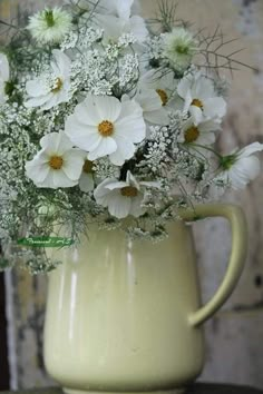 a vase filled with white flowers on top of a table