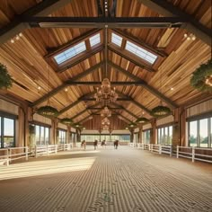 the inside of a horse barn with people walking around