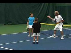 two boys and an older man on a tennis court