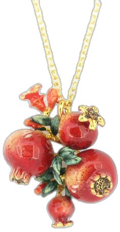 a necklace with some fruit on it and gold chains hanging from the neckline,