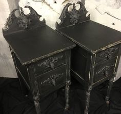 pair of black painted nightstands with ornate carvings