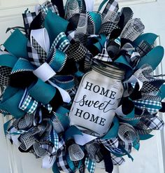 a blue and white wreath with the words home sweet home on it