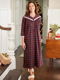 This lightweight flannel nightgown inspires cozy nights spent reading a book by the fire and sipping hot cocoa. The soft brushed cotton flannel and roomy fit leave you feeling comfy, and the pretty lace isn't the only detail you'll love! This flannel nightgown also features pintuck accents, a banded collar, 3/4 sleeves, and a rich plaid with a festive look, making this nightgown great for the holidays and beyond! Lightweight brushed flannel Longer length Beautiful red berry plaid with a pop of charcoal gray Classic Henley neckline Button placket Soft lace trim around neckline and cuffs 3/4 sleeves Horizontal pintucks Side-seam pockets Approx. 50" long 100% cotton Machine wash and dry Imported Exclusive to The Vermont Country Store Coordinating Ella Simone Lace and Plaid Cotton Flannel Paja Red Cotton Nightgown For Loungewear, Red Long Sleeve Nightgown For Home, Red Fall Sleepwear, Red Sleepwear For Fall, Long Flannel, Flannel Nightgown, Vermont Country Store, Country Store, Sleepwear & Loungewear