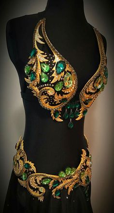 a black dress with gold and green jewels on it