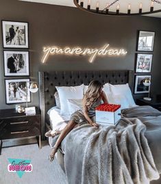 a woman sitting on top of a bed with a laptop computer in front of her