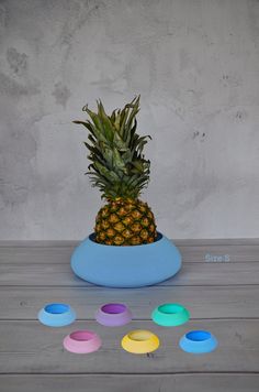 a pineapple sitting on top of a blue bowl