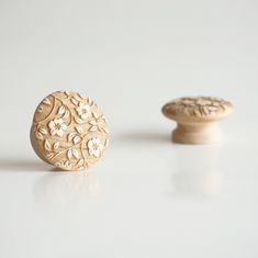 two wooden knobs sitting next to each other on a white surface