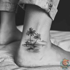 a small palm tree tattoo on the ankle