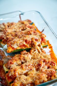 a casserole dish with zucchini and sauce in it, ready to be eaten