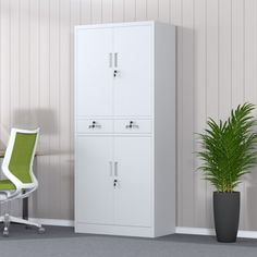 a white cabinet sitting next to a green chair in an empty office space with a potted plant on the floor