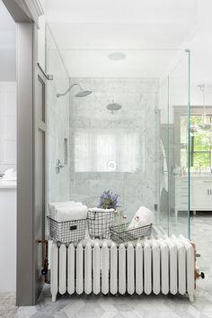 a bathroom with a radiator, sink and shower in the middle of it