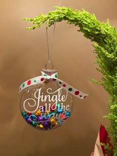 a christmas ornament hanging from a tree with the words jungle all the way on it