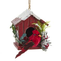 a red birdhouse with a cardinal sitting on it's perch