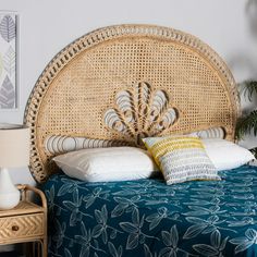 a wicker headboard on a bed in a bedroom with blue bedspread