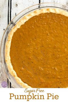 a pumpkin pie sitting on top of a wooden table with the words sugar free pumpkin pie