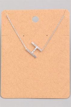 The Sideways Initial Necklace is a modern twist on the classic design, a must-have. This letter necklace is great for everyday wear or layering.- Asymmetrical Initial Necklace - Silver Plated- Brushed Textured Metals- Initial Size: 0.75"- Letter: H- L: 17" + 2" Extender- Lobster Clasp Closure Small Initial Necklace, H Necklace, Lily Jewelry, Initial Necklace Silver, Sideways Initial Necklace, Letter H, Letter Necklace, 16th Birthday, Metal Design