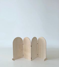 three wooden archs sitting next to each other on a white surface