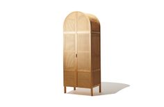 a tall wooden cabinet sitting on top of a white floor