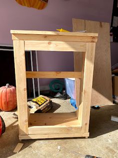 a wooden shelf with some tools on it in the middle of a room filled with pumpkins