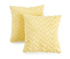 two yellow pillows sitting next to each other