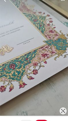 an ornate wedding card with gold trimmings and floral designs on the front side