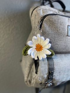 a backpack with a flower attached to it